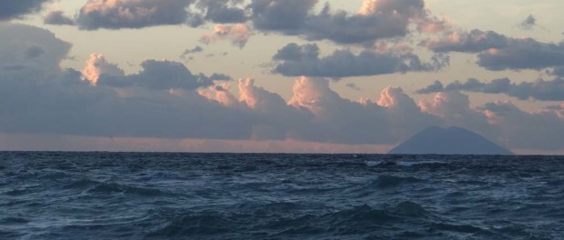 Mount Stromboli, one of Italy's three active volcanoes, you can visit it, but the sea looks viscous! We spotted what appears to be a twister to the left of it.