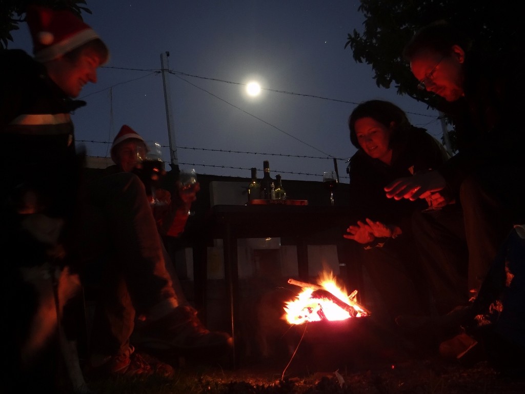 Warming around the fire under the moonlight - perfect!