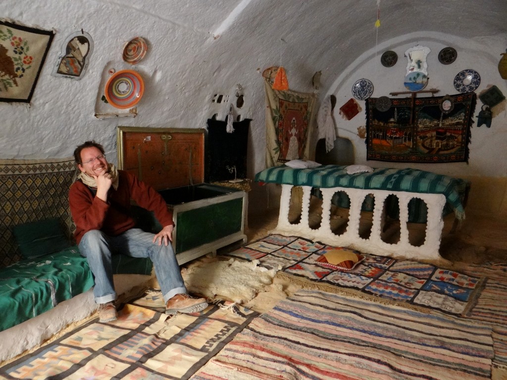 Jay relaxing in the pit dwelling museum bedroom