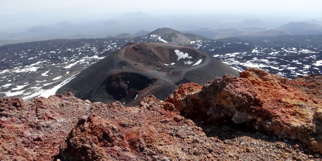 Looking down over some craters to the sea.