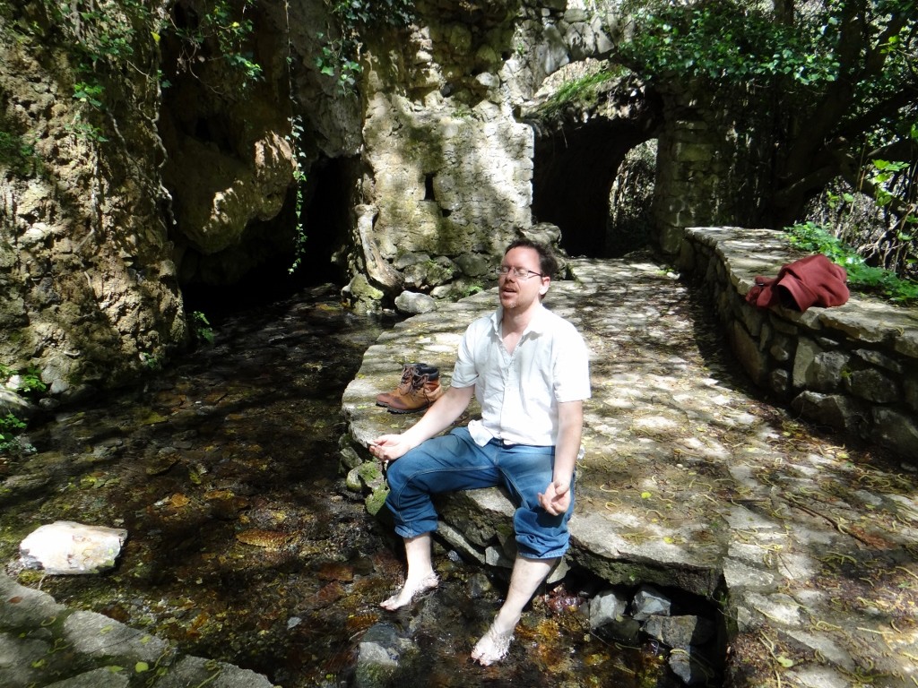 Jay soaks his feet in the icy water