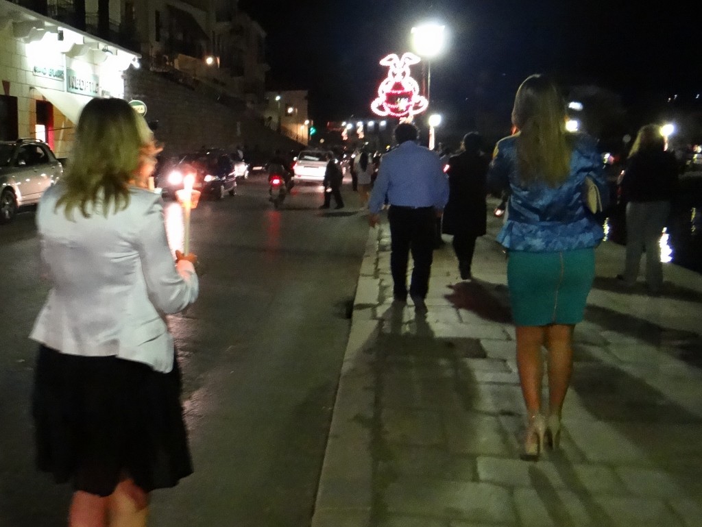 Everyone walking back with the lit candles in their Sunday best - we felt a bit scruffy