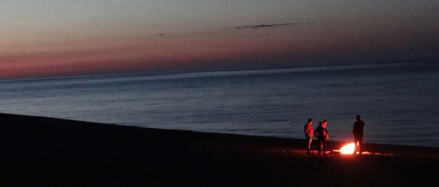 Locals keeping warm on the beach at Horefto