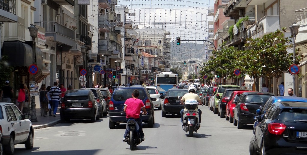 Busy Volos - the Christmas/Easter lights are still up - and on the right you can see the head of a chap about to ride his scooter right across the front of us!