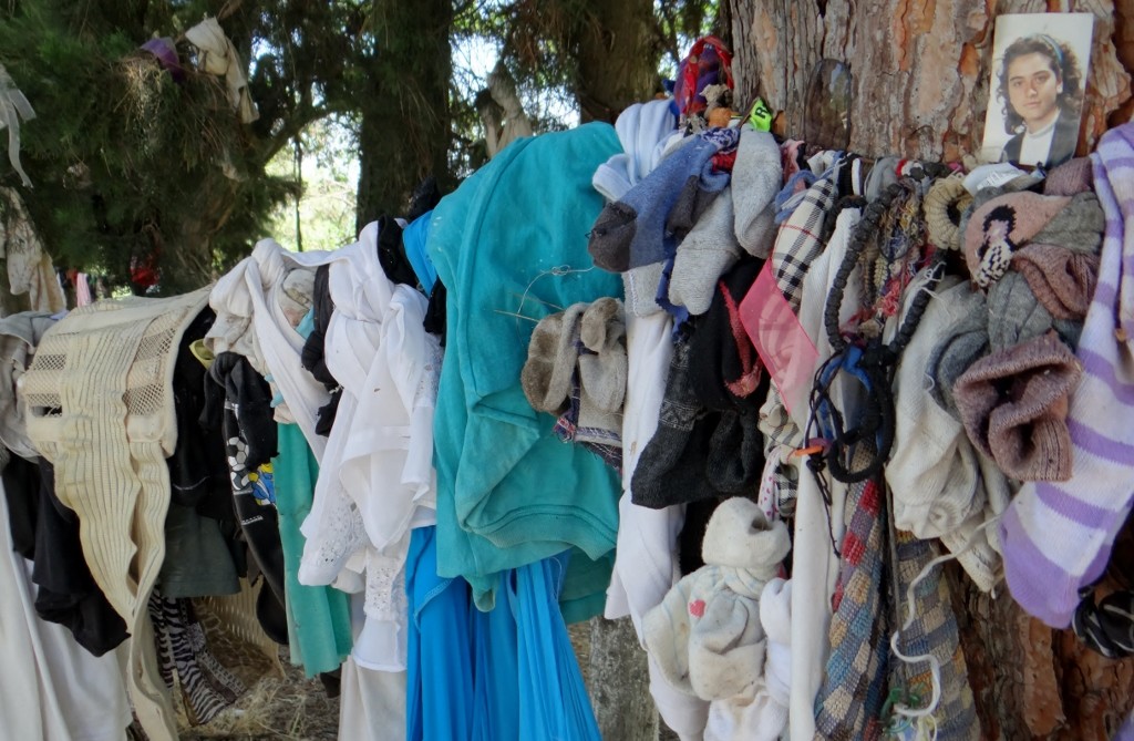 Offerings tied to a tree outside the church/shrine included photos, bracelets, bras, socks and a girdle!