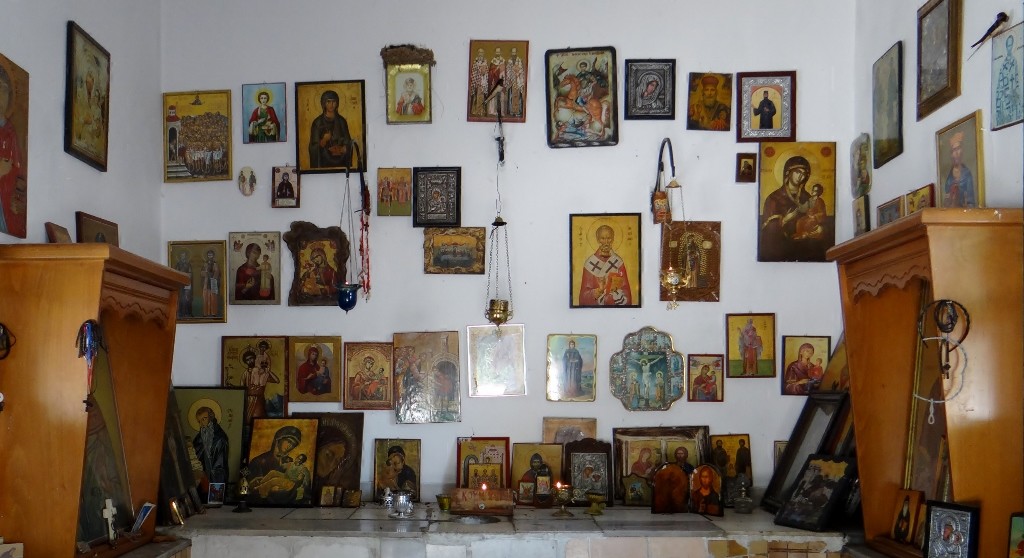 Inside the little shrine/church - fifth painting from the left on the top row is home to the birds nest, can you spot the two adults watching me?