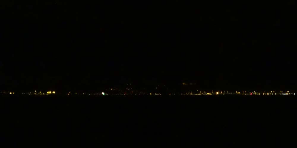 The twinkling lights of England to my right.