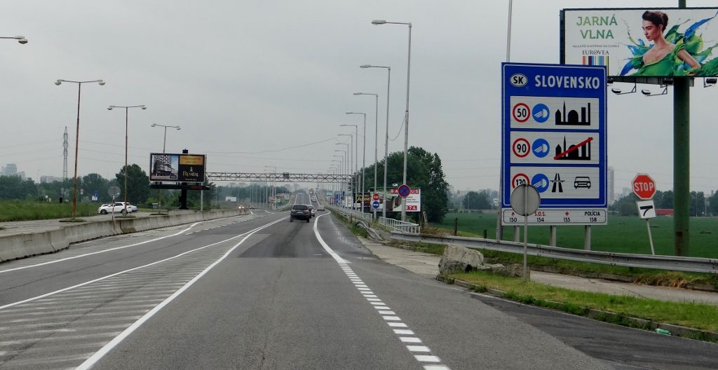 Another country, another set of rules. I just keep dipped headlights on everywhere as some countries want 'em on, others don't