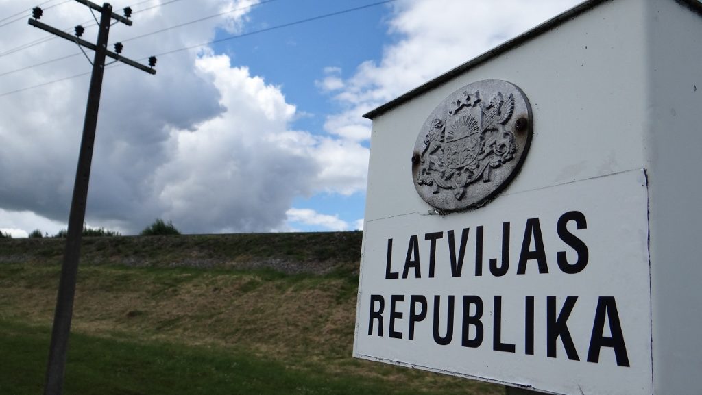 Little black and white posts stand across the countryside and through town demarking the border