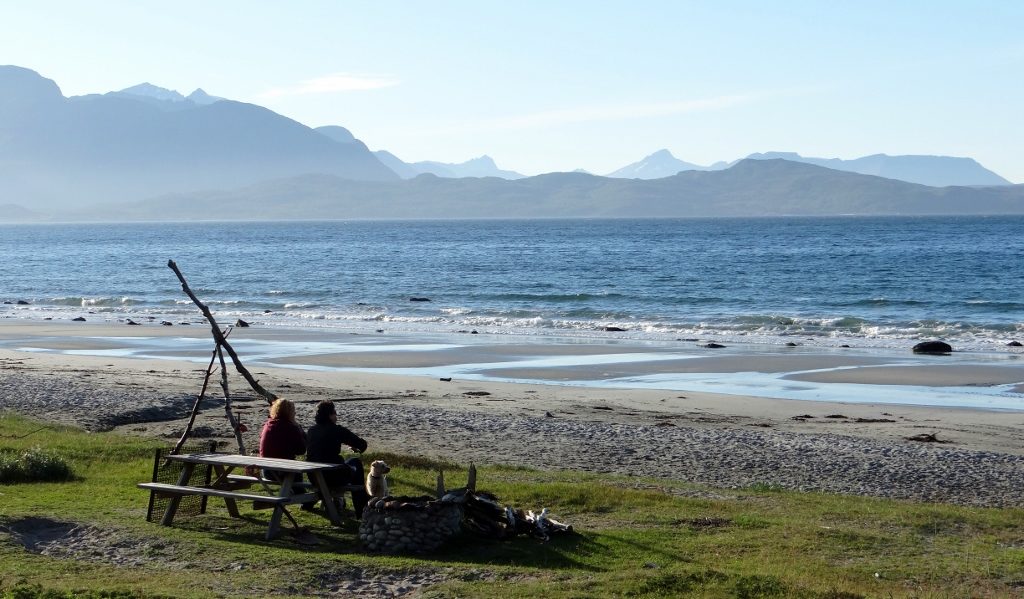 Fire pit on the beach, mountains in background, heaven.