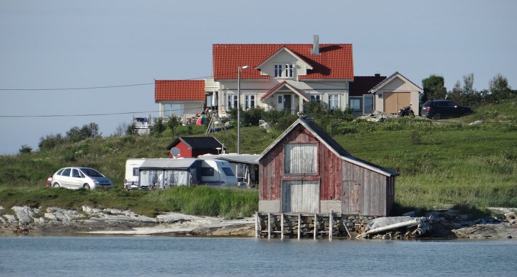 An old fishing house fronts a modern place to the rear. Houses here tend to be concrete up to the first floor, then wood above.