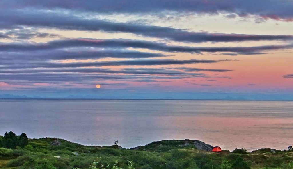 Tent and moonrise Lofoten Islands Norway