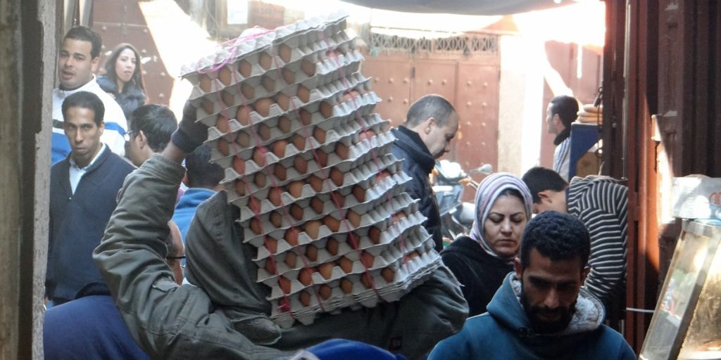 Eggs being carried, carefully, along a busy alley