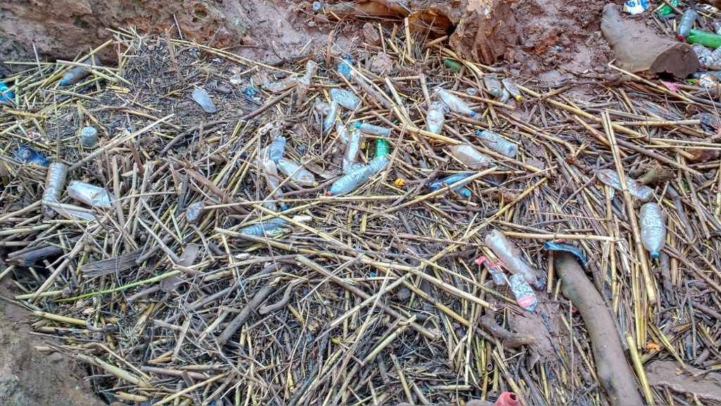 Rubbish collecting in a pool at the bottom of the falls. Folks sit about. No-one collects it, drags it off and burns it. Instead rubbish is being thrown into the valley just a short distance from the tumbling waters