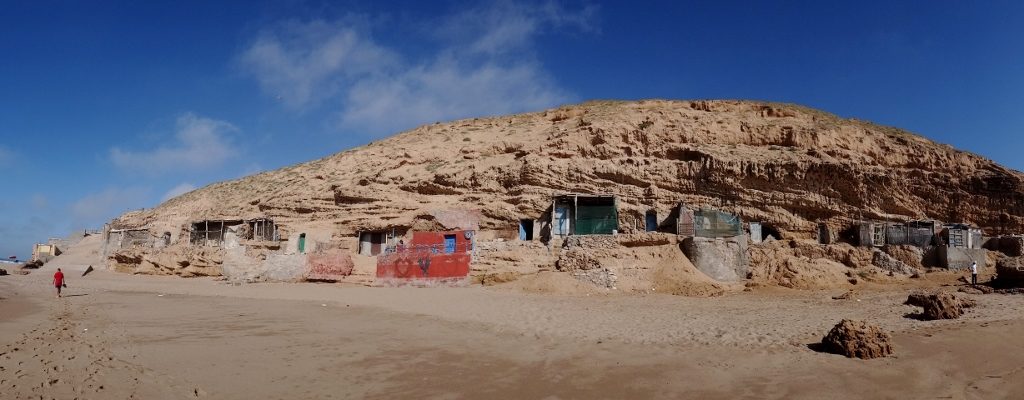 Fishermen's lodges built into the rock face below us