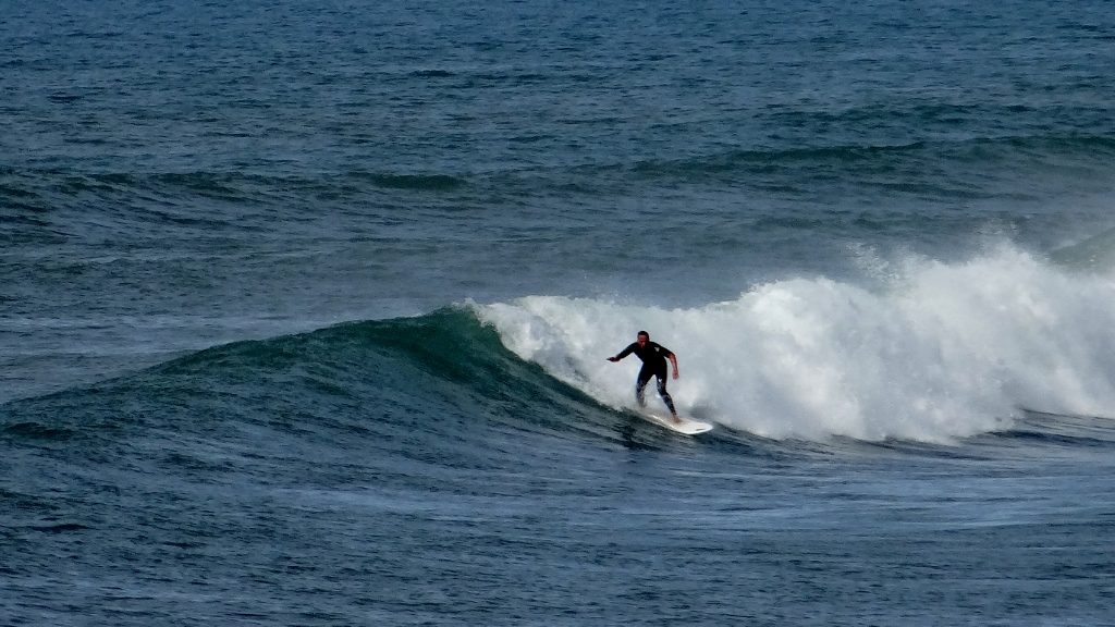 There are a handful of surfers and stand up paddle boarders here enjoying the daytime surf