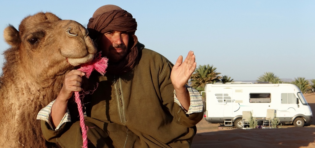 Phil and Jule's camel man in front of Big Ben. They found him asleep next to the camels, waiting for them to arrive.