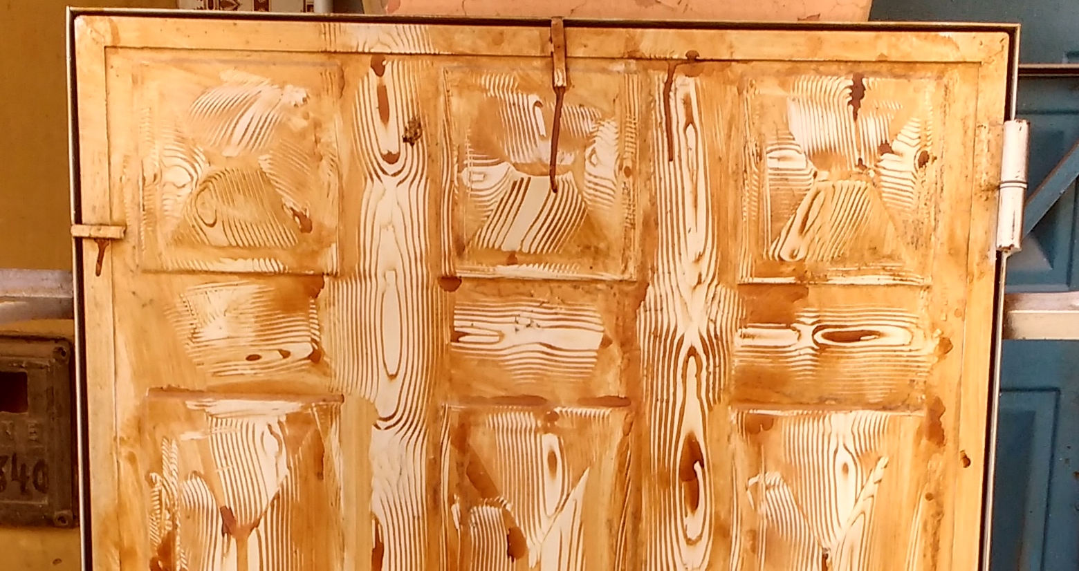 Doors here are generally made from metal, as palm wood's too fibrous (this of many Weetabix glued together). So a bit of paint-and-grain's occasionally deployed to unconvincing effect!