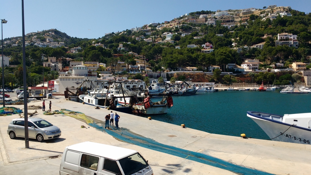 Fishermen mending nets at the Javea port