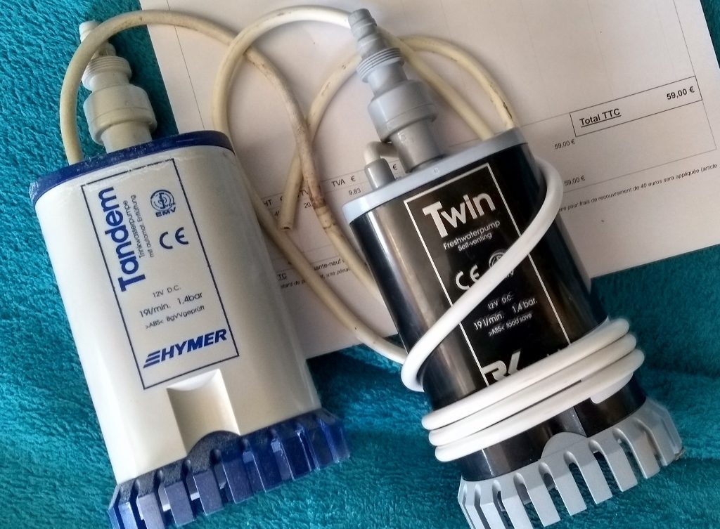 The old (grey and blue) and new (black) water pumps for our Hymer