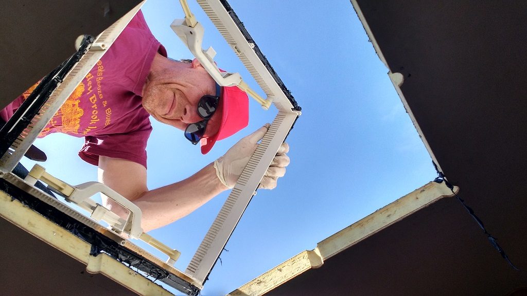 Lifting off the old skylight housing