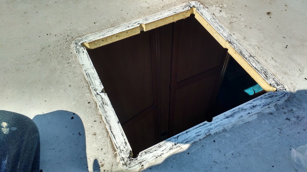 The existing aperture before cleaning up all the existing mastic.