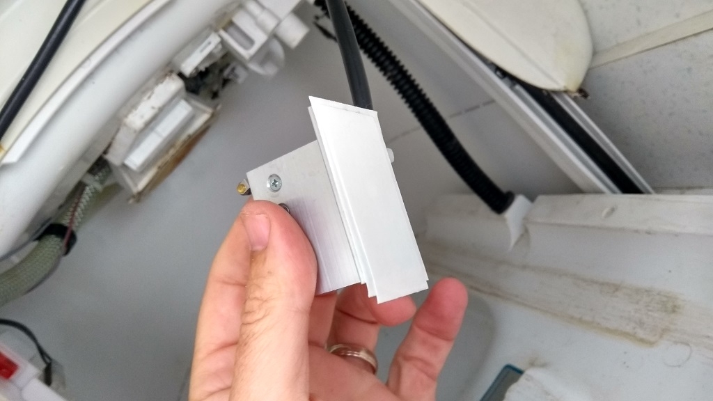 With the connections soldered, a couple of sheet of double-sided tape went on the SOG switch bracket to re-attach it