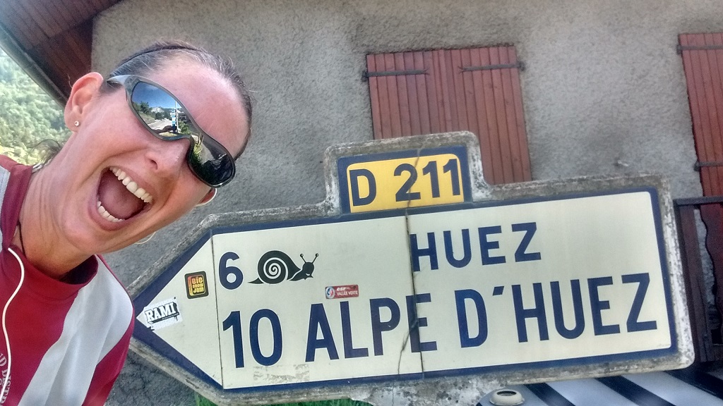 Running up Alpe d'Huez with a sign saying 10km to go