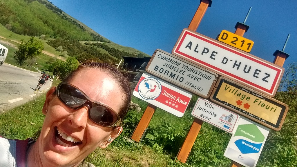 Runner at the Alpe d'Huez  ski station sign 