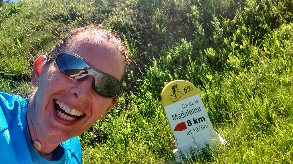 A runner at the 8km to go cyclist marker on the col de la madeleine