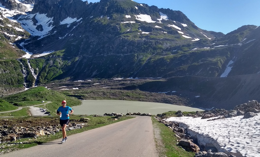 Runner uphill running Alps Switzerland