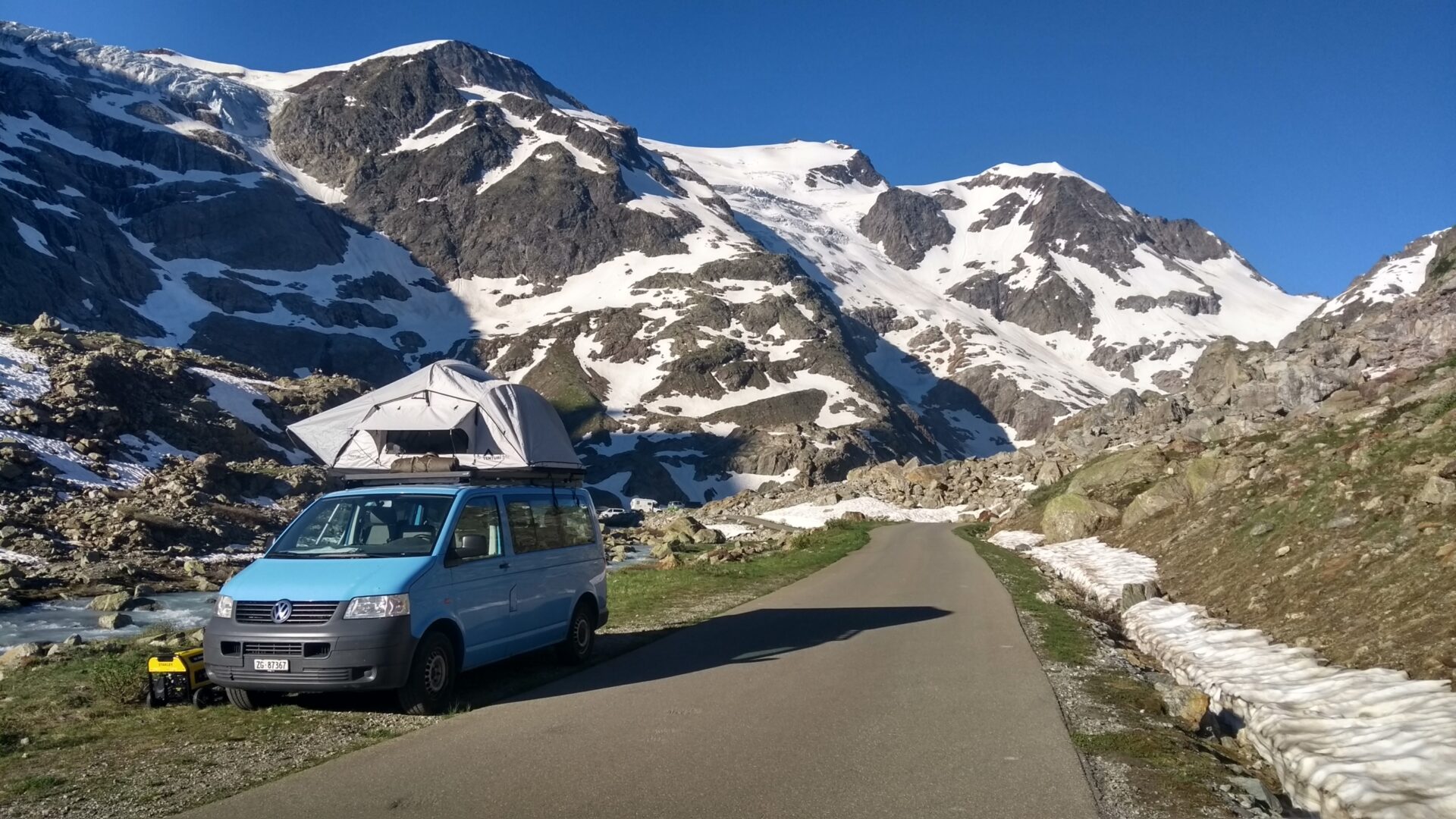 VW camper roof tent mountains snow Switzerland