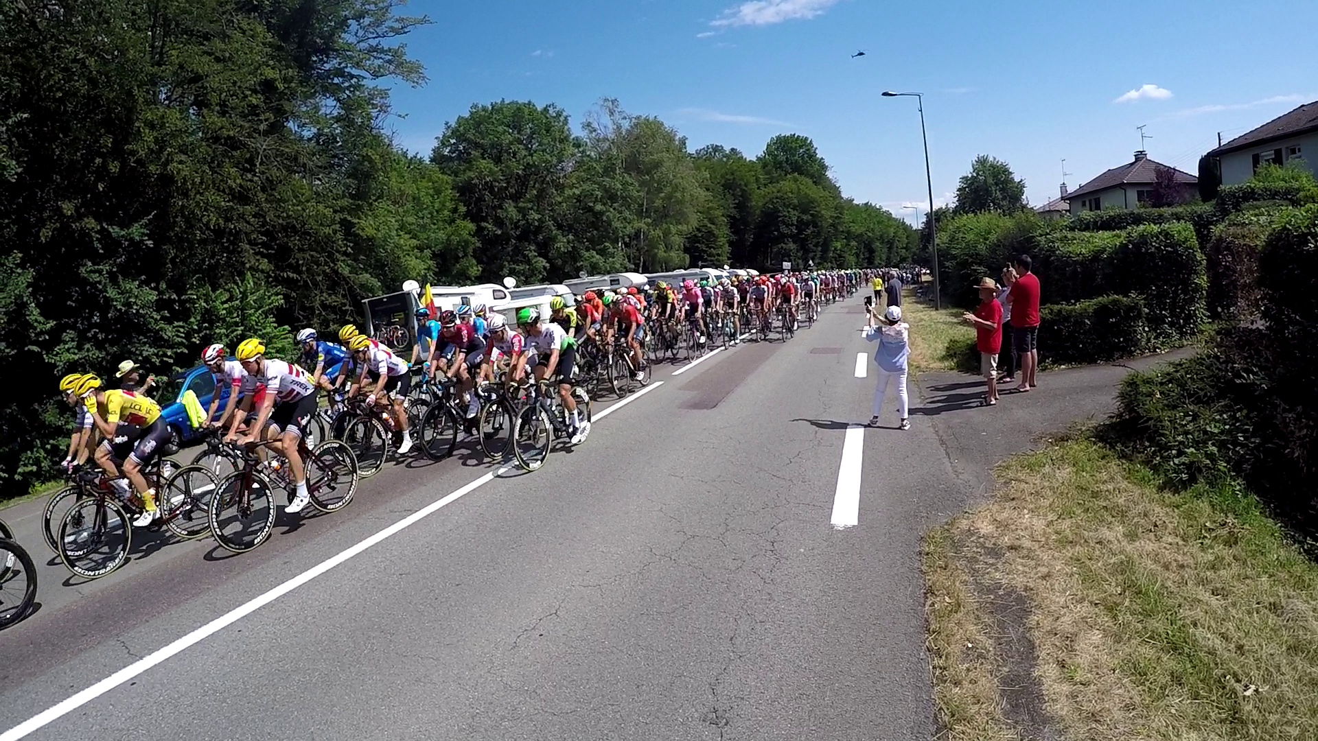 The Tour de France peleton pours past in a flash of colour