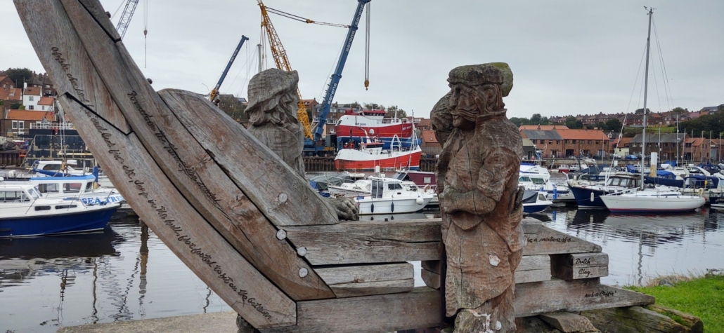 A monument to Whitby's boat builders of old, with the modern day Parkol's in the background