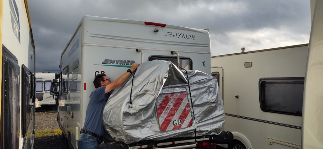 We've got a new bike cover after the last one was eaten by the sun and wind. We need the striped signal board to be legal in Spain