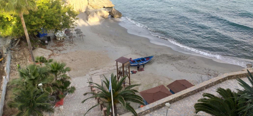 Fishermen sorting nets out on the beach alongside