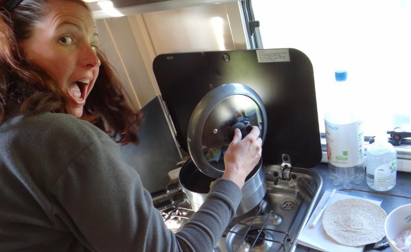 Cooking in a motorhome kitchen on the hob using a double skillet