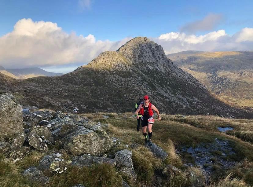 An ultra runner with Tyrfan and the Heather Terrace in the background. Source: www.gbultras.com