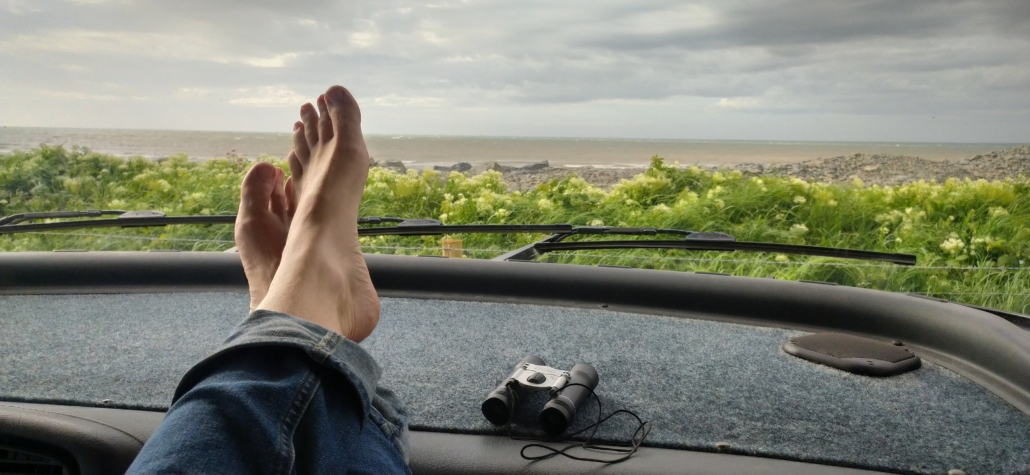Feet dashboard motorhome view sea beach