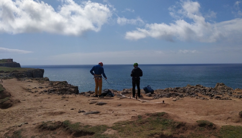 Climbers preparing to descend the cliff face at St Govan's