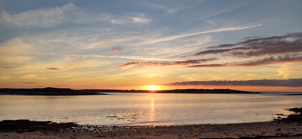 Sunset over the beaches and granite of Île-Grande