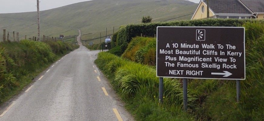 road sign advertising cliff views