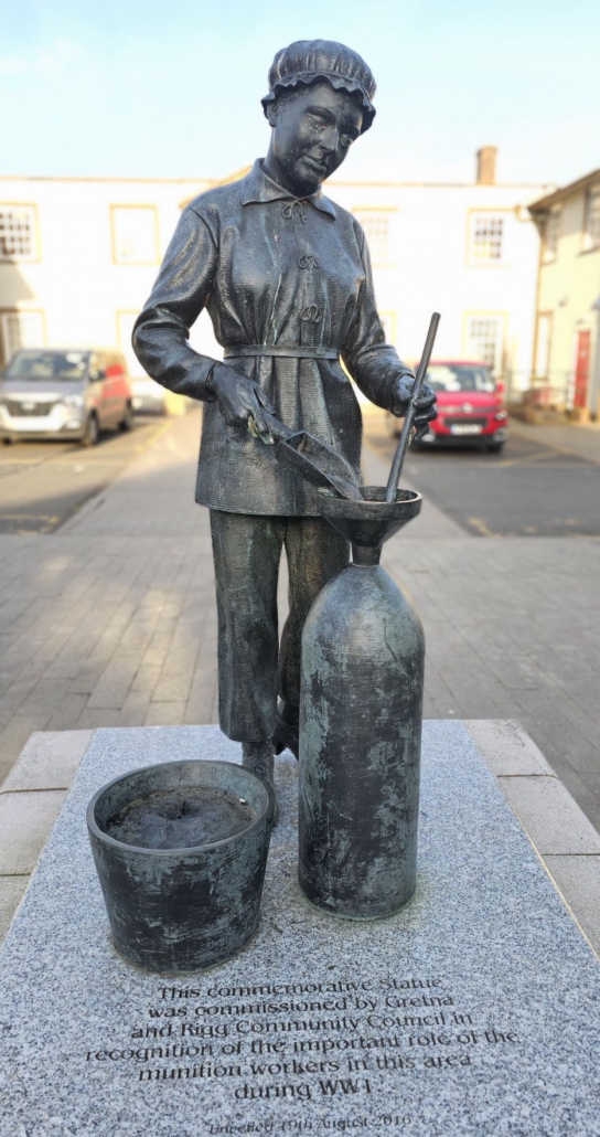 Statue of girl filling munition shell 