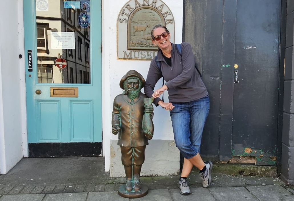 Ju with small staute of fisherman outside Stranraer museum
