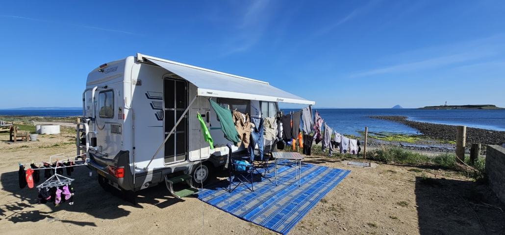 Motorhome covered with drying clothes on a campsite