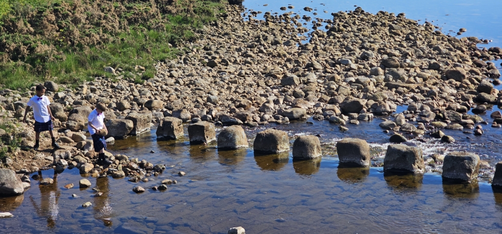 Boys in kilts by river