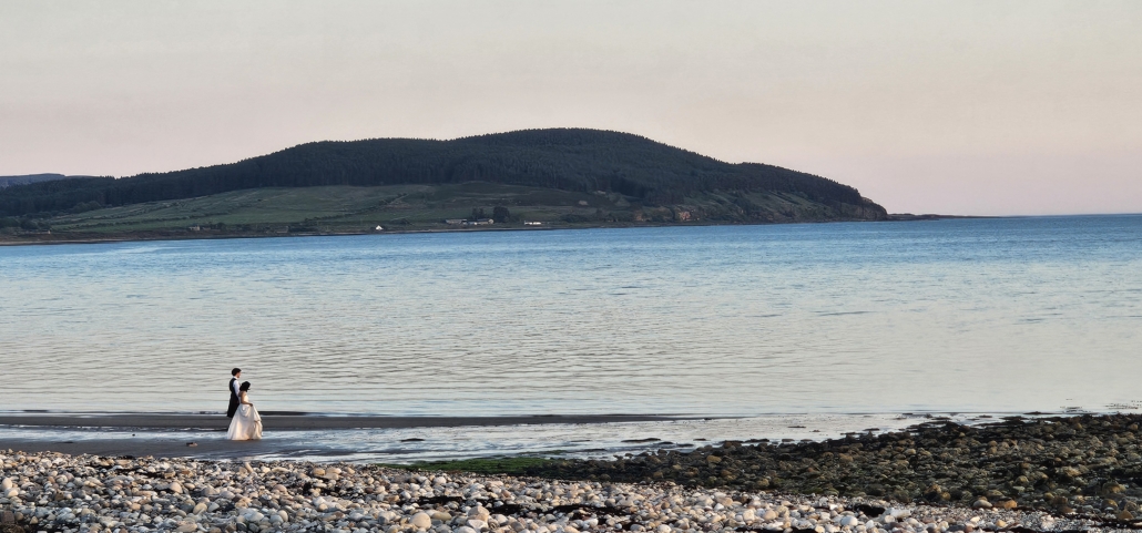 Bride and Groom on beach at sunset