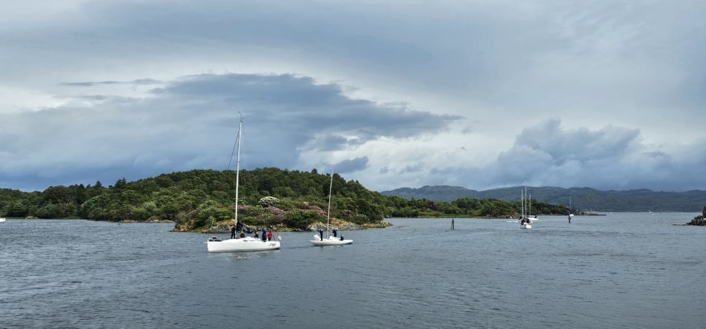 yachts sailing in to shore from the sea