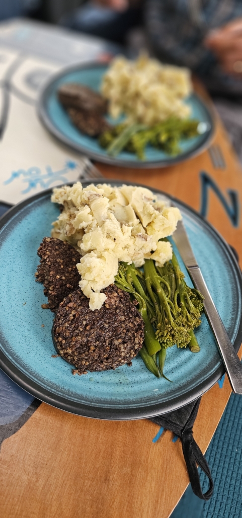 Haggis, mashed potatoes and veggies on a plate