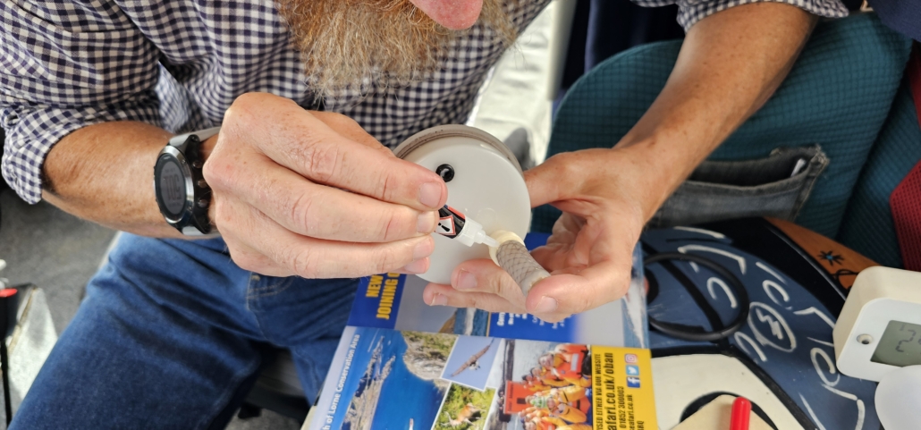 Jay gluing part of the water system together to repair it